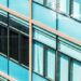 A modern commercial building with energy-efficient glass windows reflecting sunlight and enhancing sustainability."
