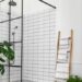 Modern shower cubicle with black metal framing and white subway tiles.
