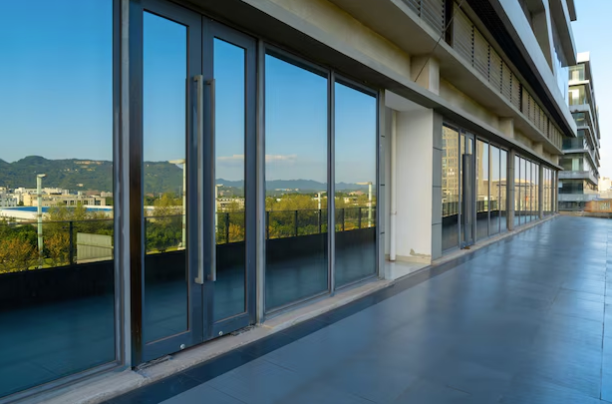 Modern commercial building showcasing the benefits of energy-efficient glass windows with sleek, reflective panels.